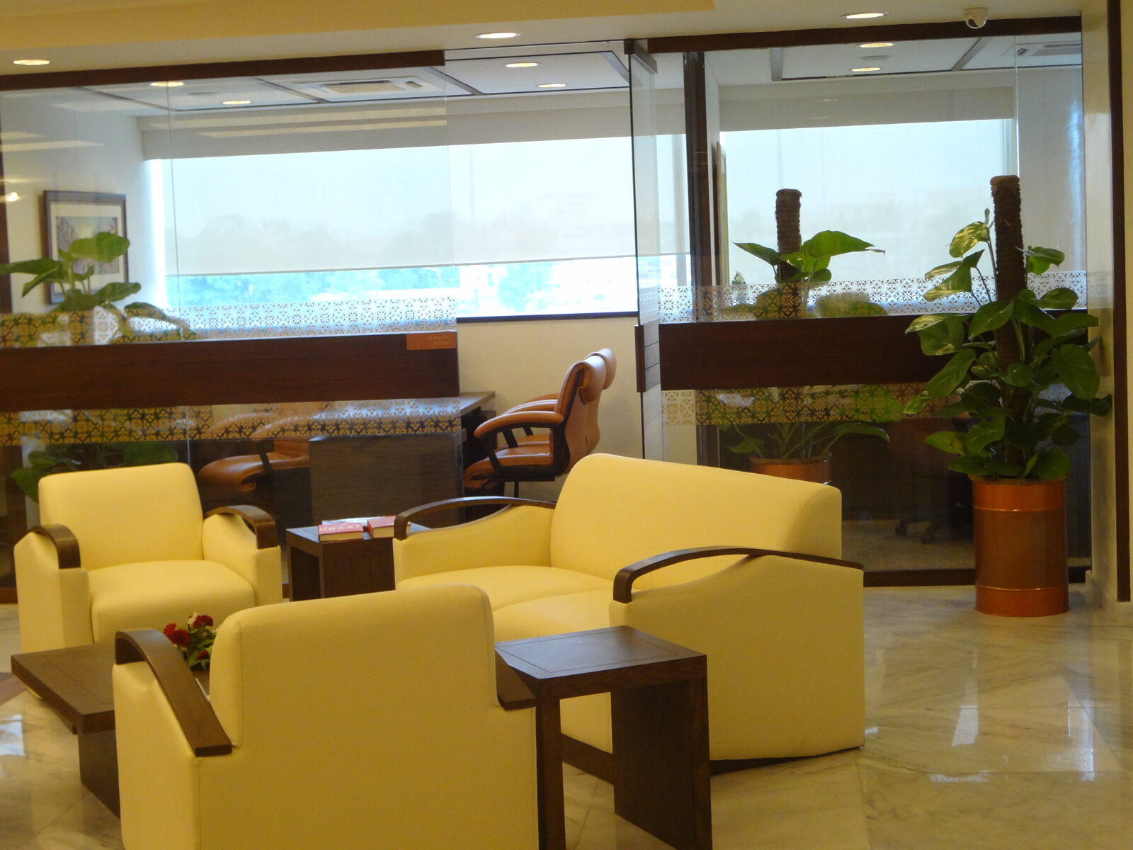 Banking lounge seating group beside glazed partitions with timber banding