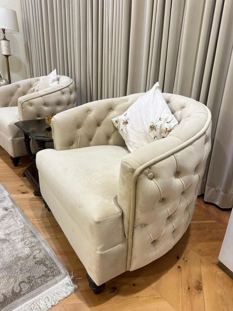 Cream buttoned tub chairs