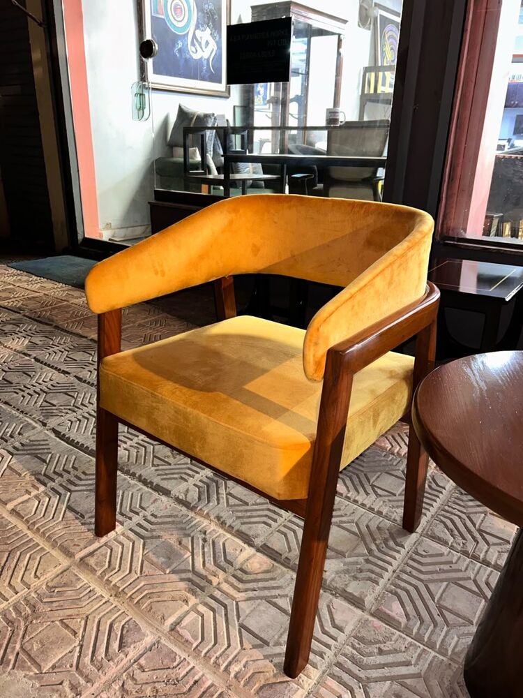 Mustard upholstered armchair with timber frame
