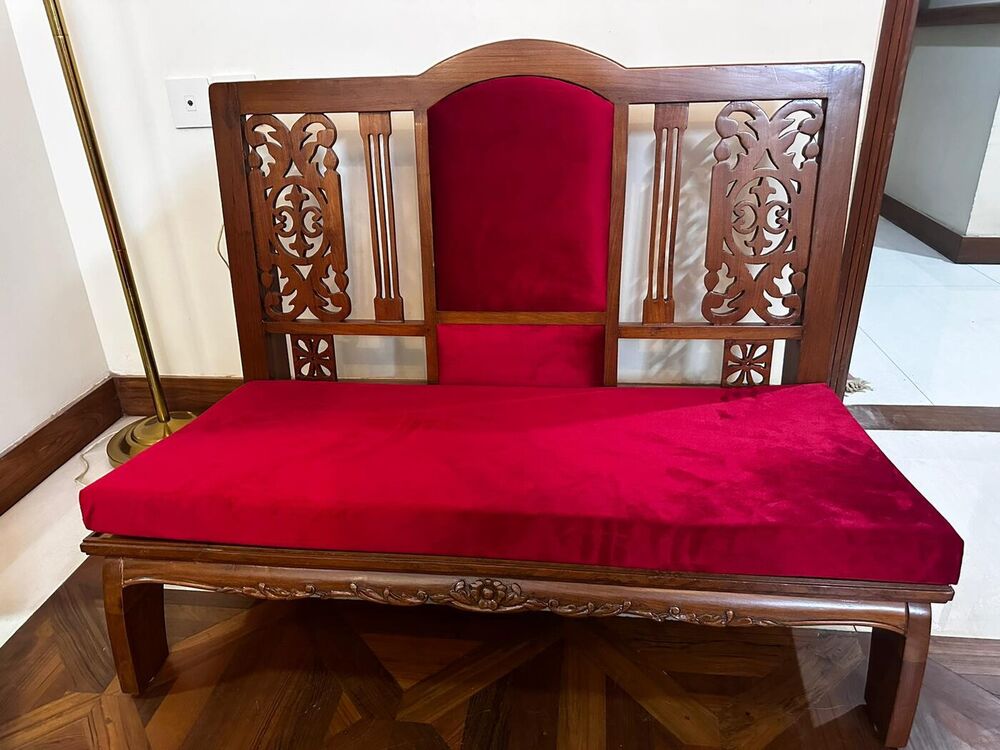 Carved timber takht with deep red velvet seat