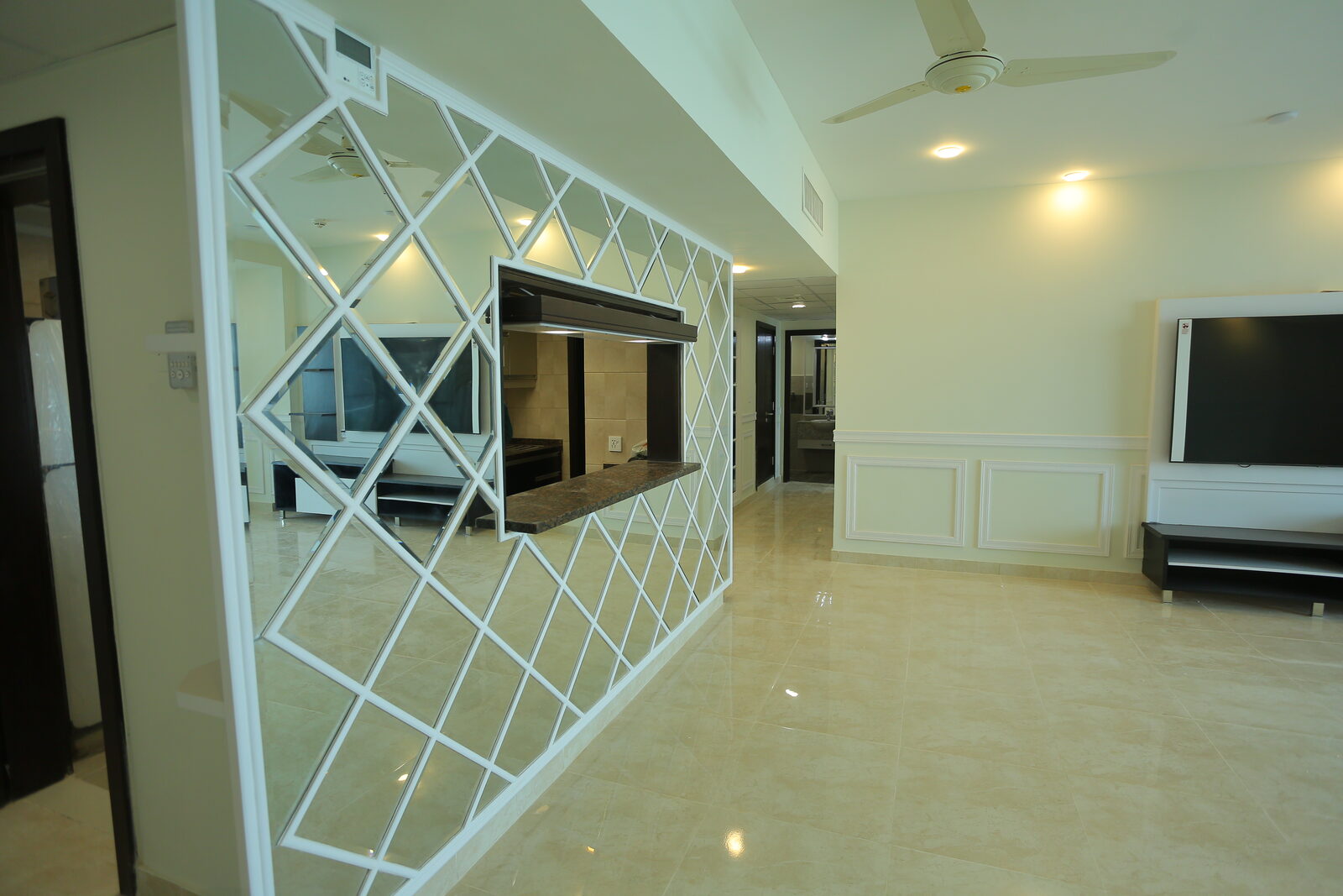 Mirrored diamond lattice partition screen with serving opening through to the kitchen